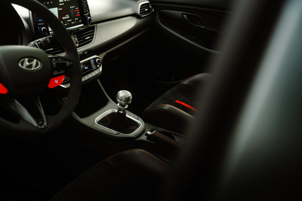 the interior of a car with a steering wheel and dashboard