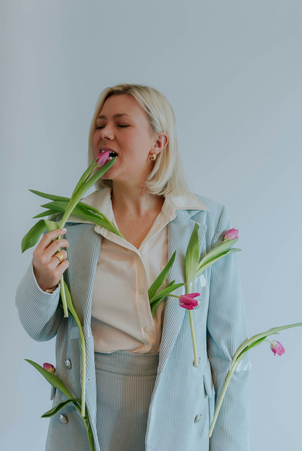 a woman is holding flowers in her hands