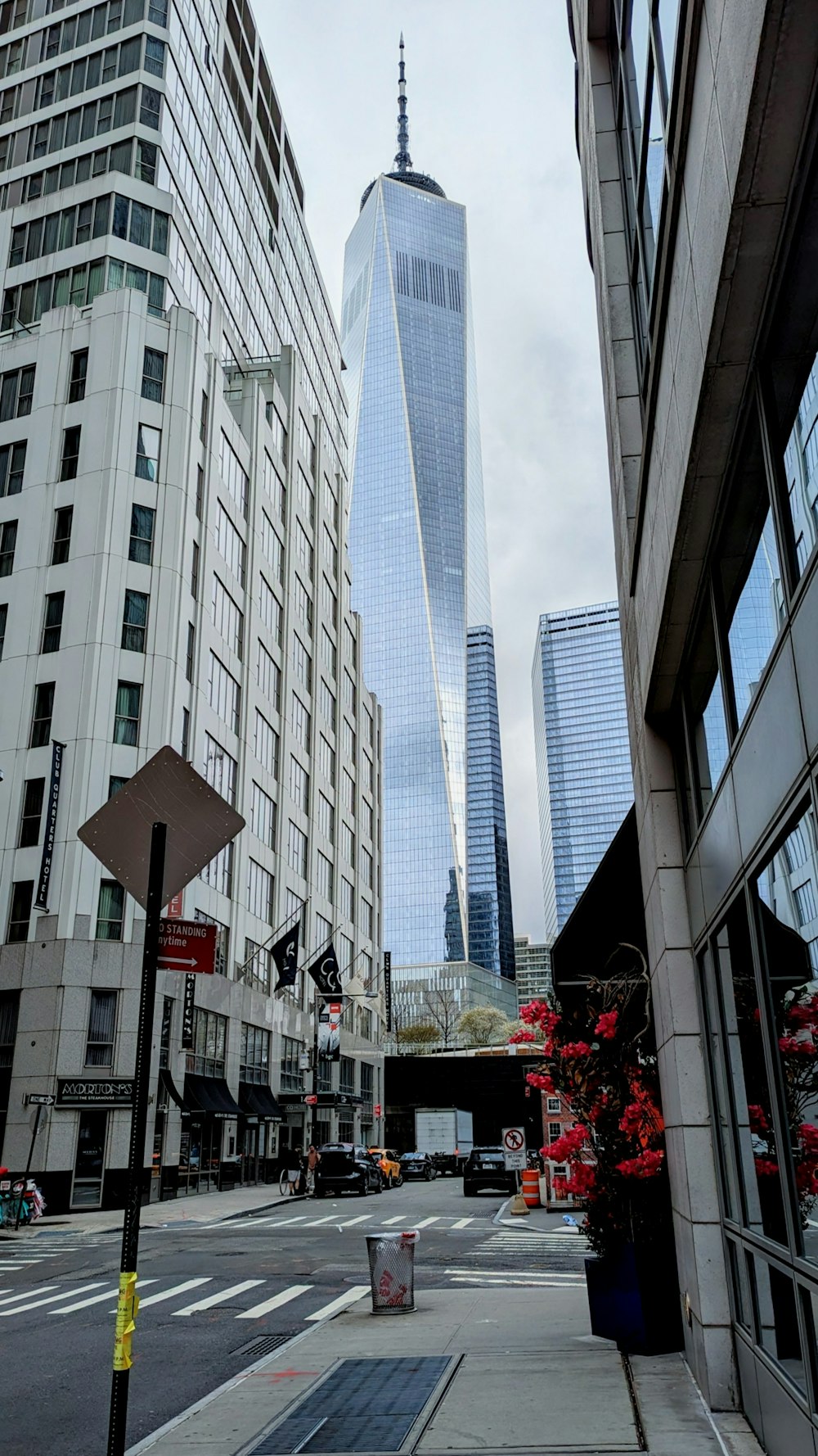 a city street with tall buildings in the background