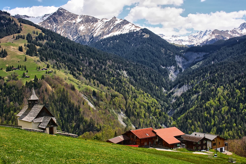 a scenic view of a mountain range with houses in the foreground