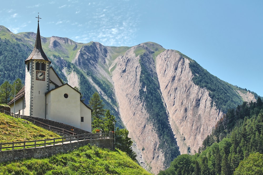 a church on a hill with mountains in the background