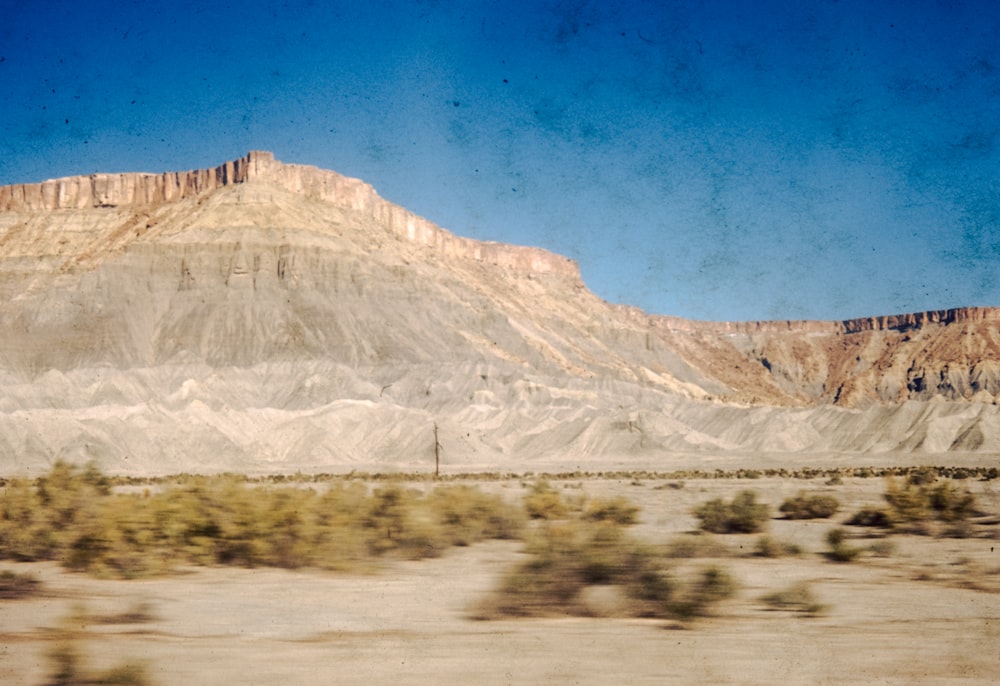 a view of a mountain from a moving car