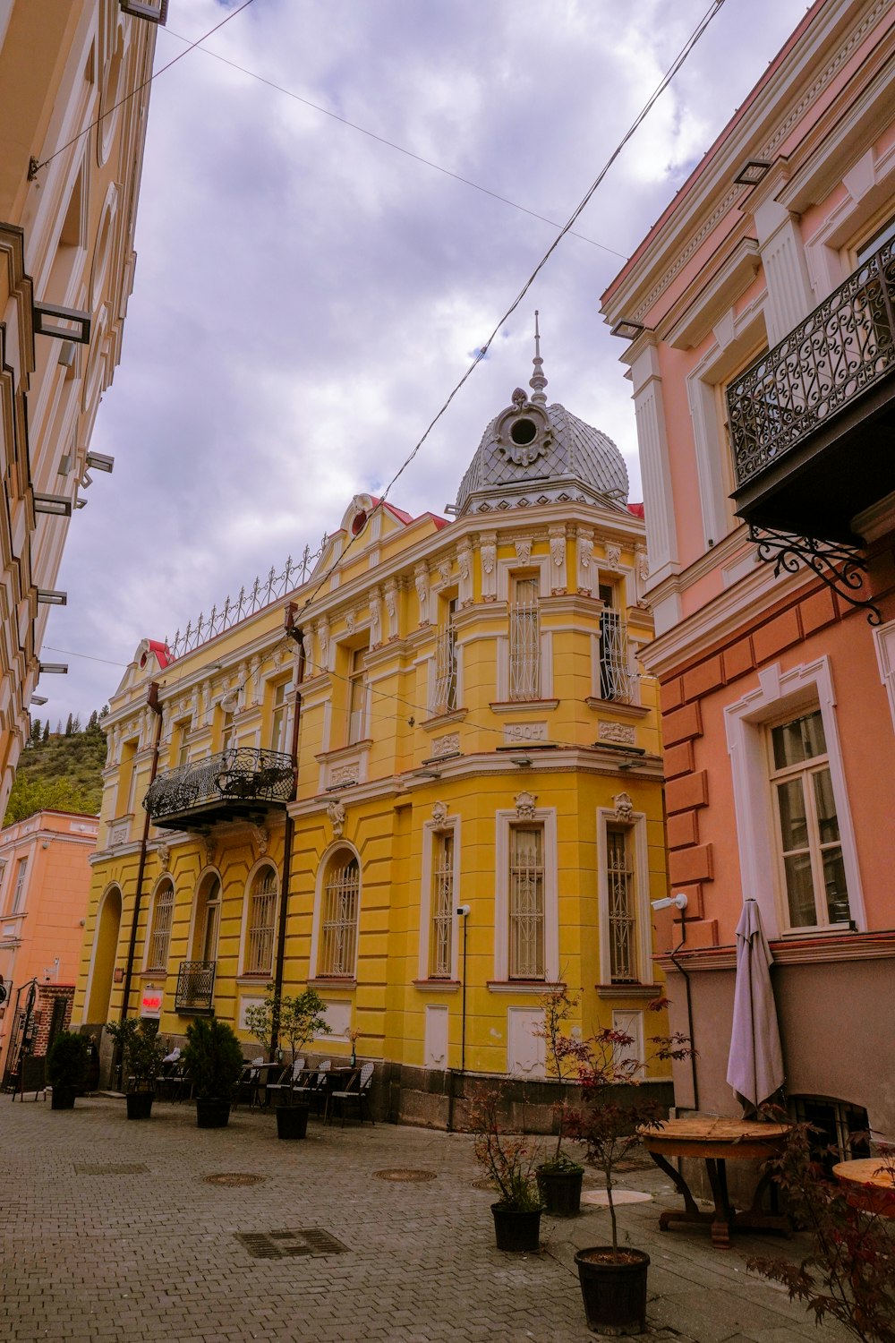 a yellow building with a clock on the top of it