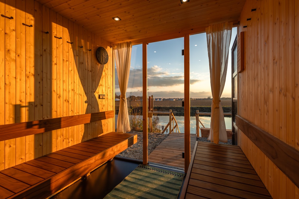 a wooden sauna with a view of a body of water