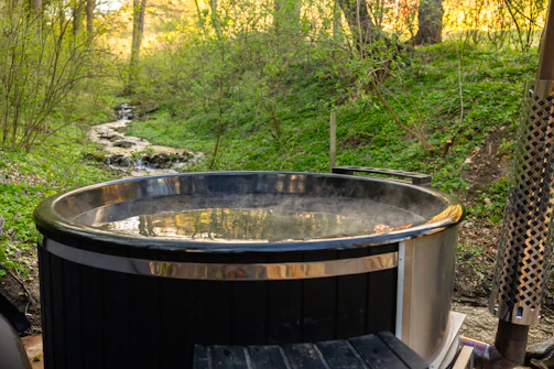 a hot tub sitting in the middle of a forest
