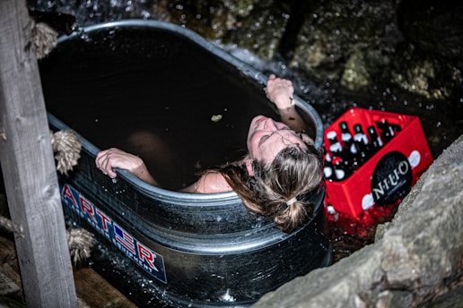a woman taking a bath in a hot tub