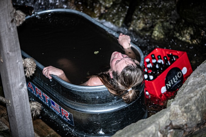 a woman taking a bath in a hot tub