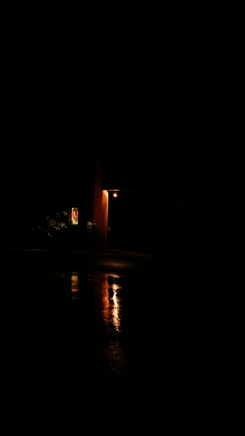 a dark picture of a building and a street light