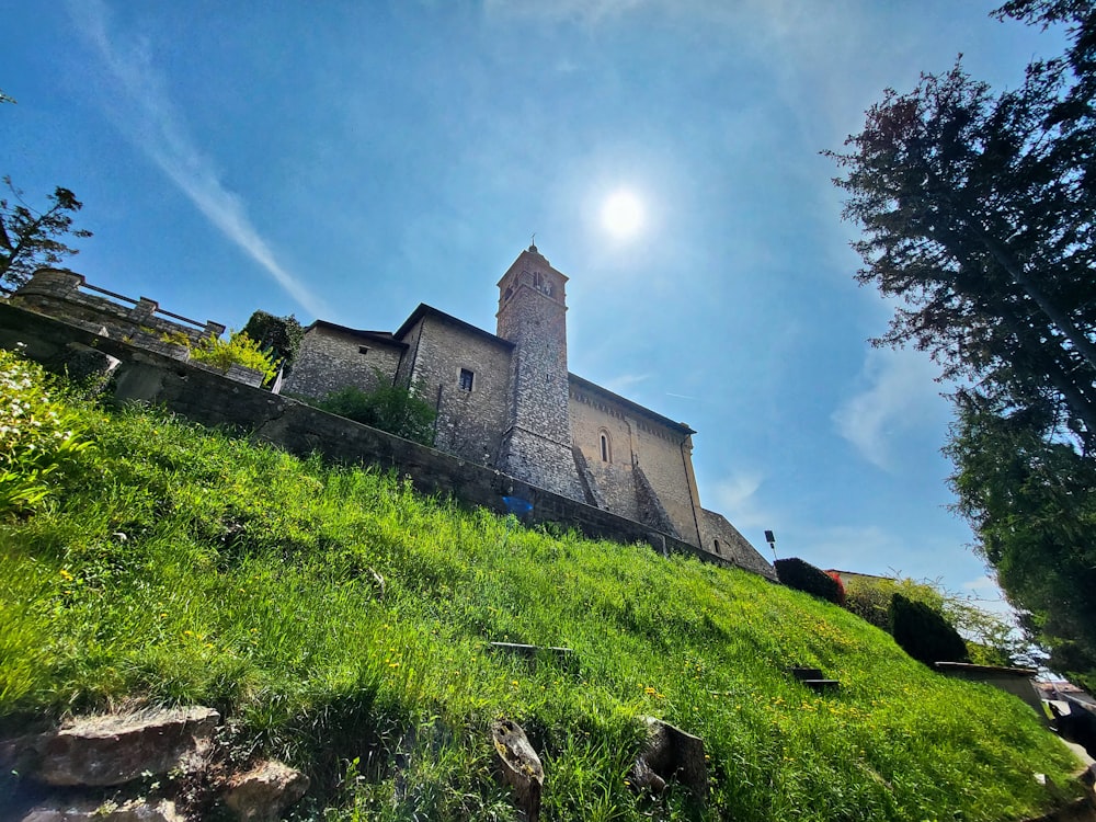 a church on top of a hill with a sky background