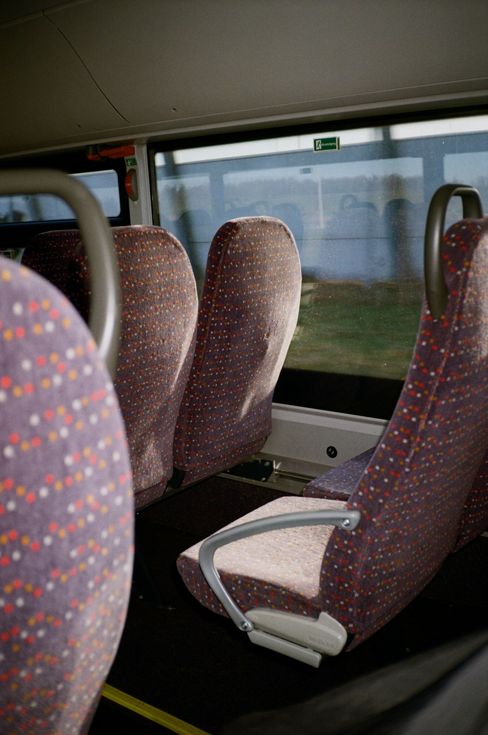 the seats in the bus are covered with colorful spots