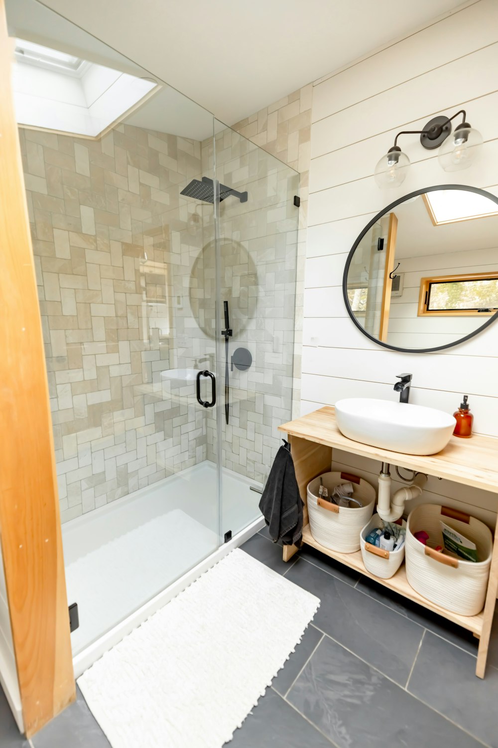 a bathroom with a walk in shower next to a sink