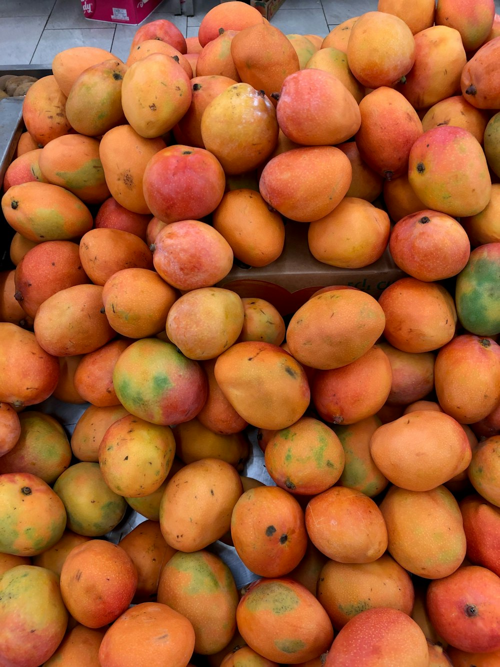 a pile of mangoes sitting on top of each other