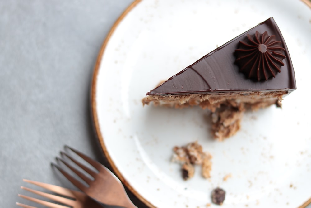 a piece of chocolate dessert on a plate with a fork