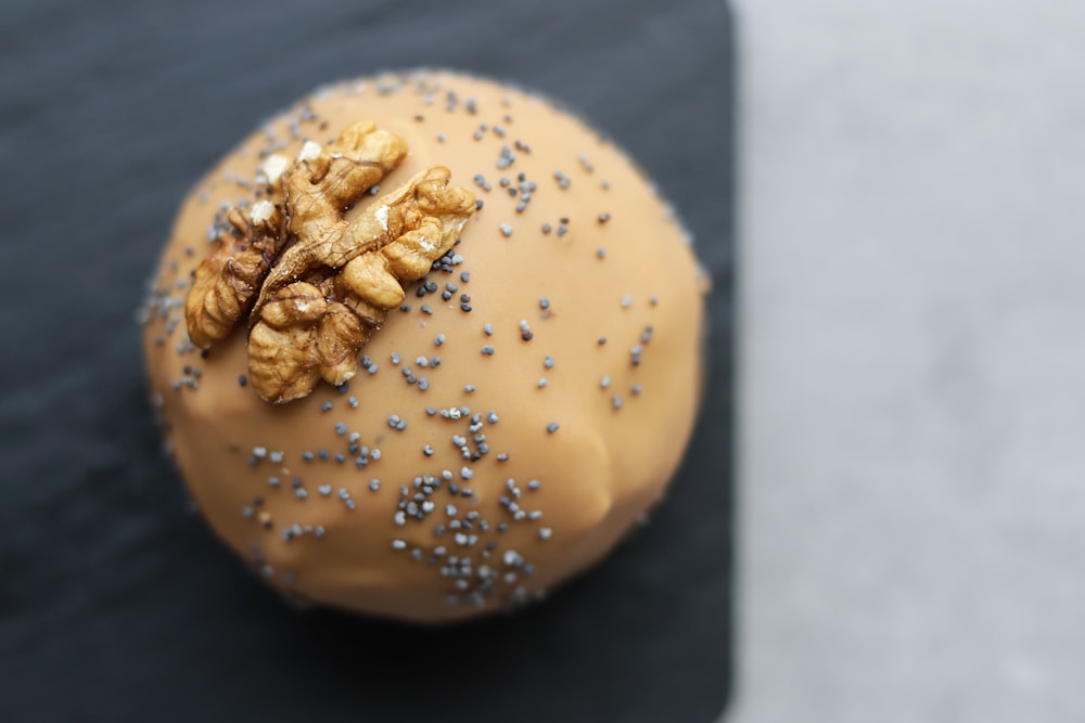 a close up of a doughnut with nuts on it