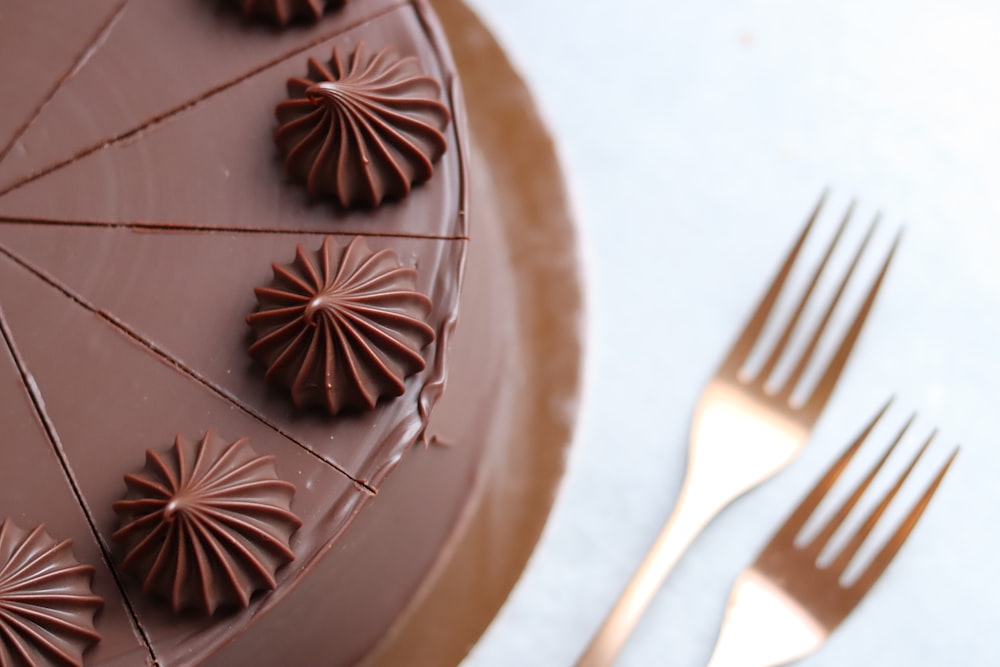 a close up of a cake with chocolate icing