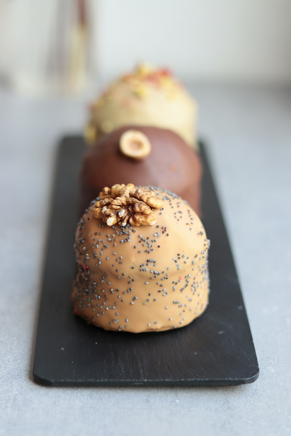 a couple of doughnuts sitting on top of a black plate