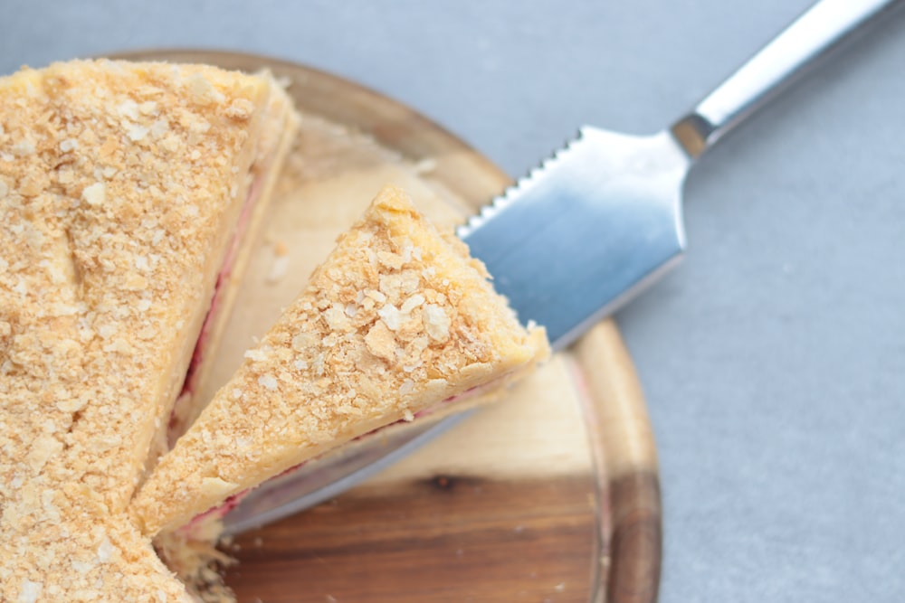 a cut in half sandwich sitting on top of a wooden cutting board