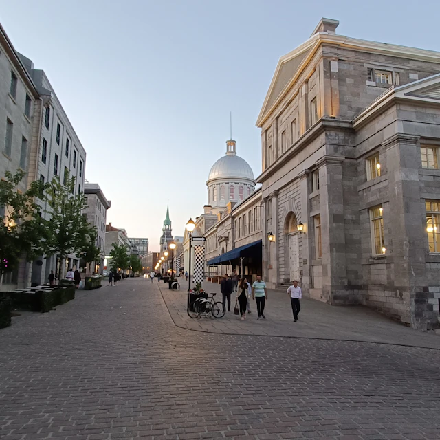 A cobblestone street lined with tall stone buildings in Old Montreal
