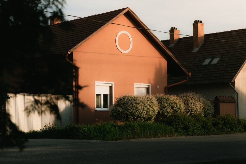 a house with a white circle on the side of it