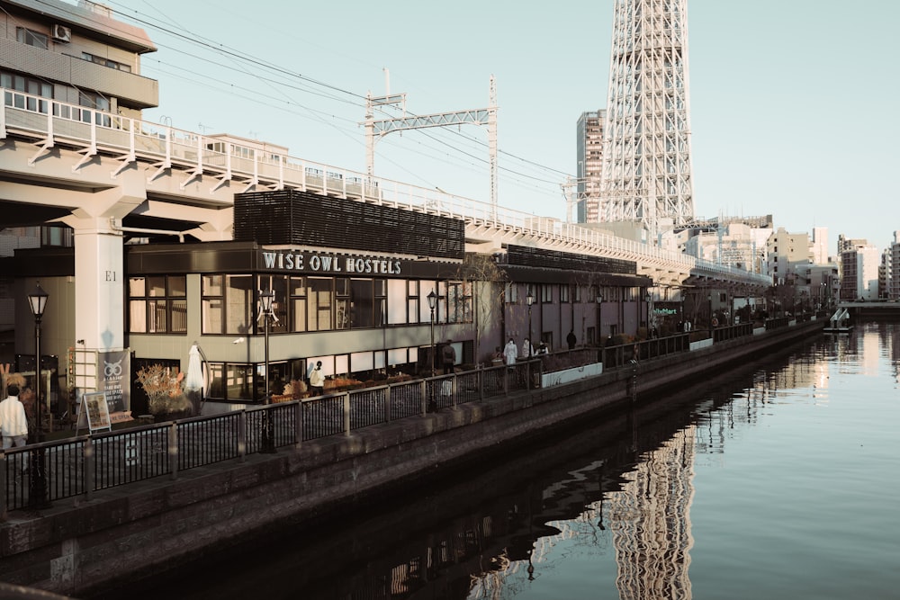 a river runs through a city next to a tall building