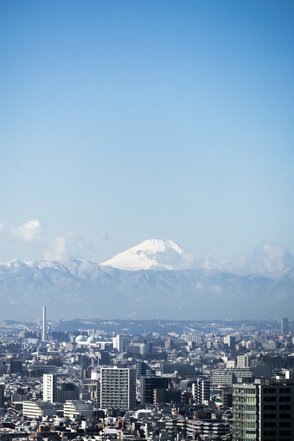 a view of a city with mountains in the background