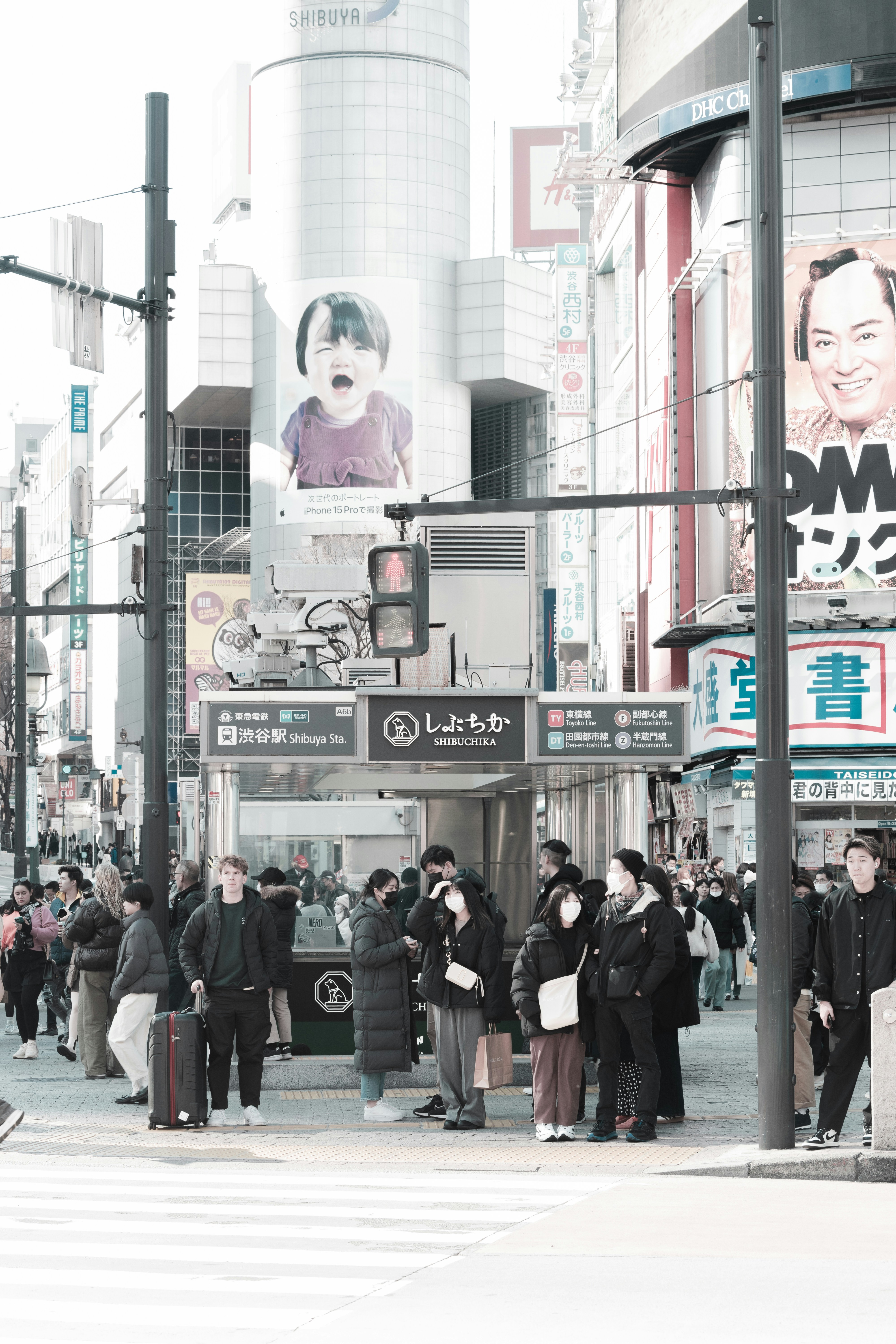 a group of people standing on a street corner