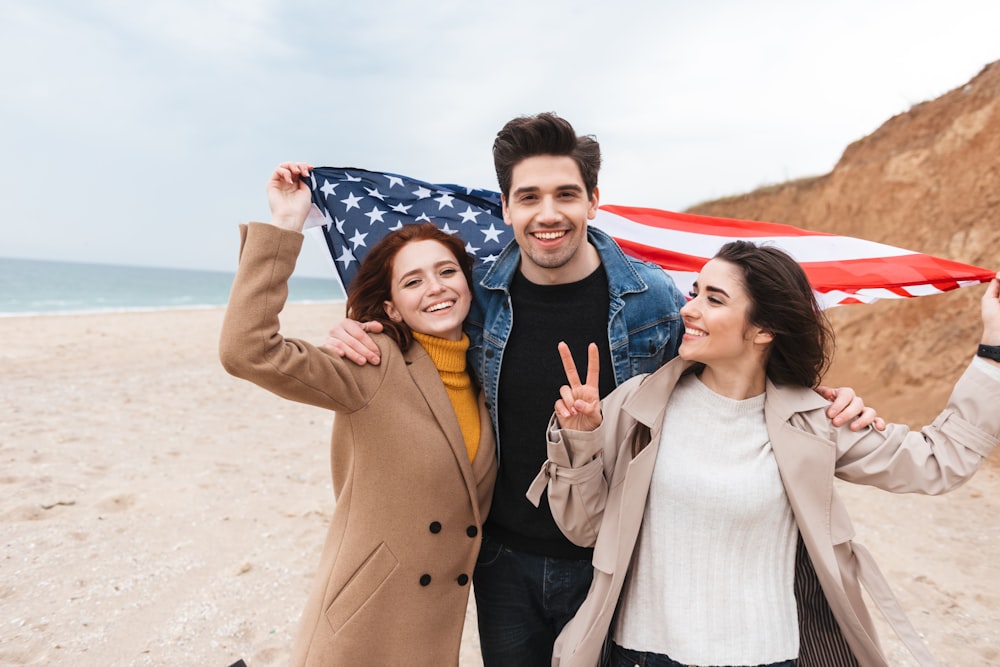 a couple of people that are standing in the sand