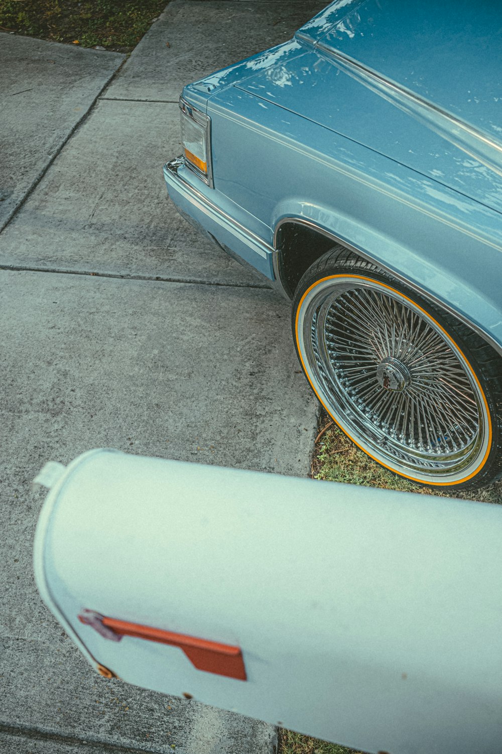 a blue car parked on the side of the road