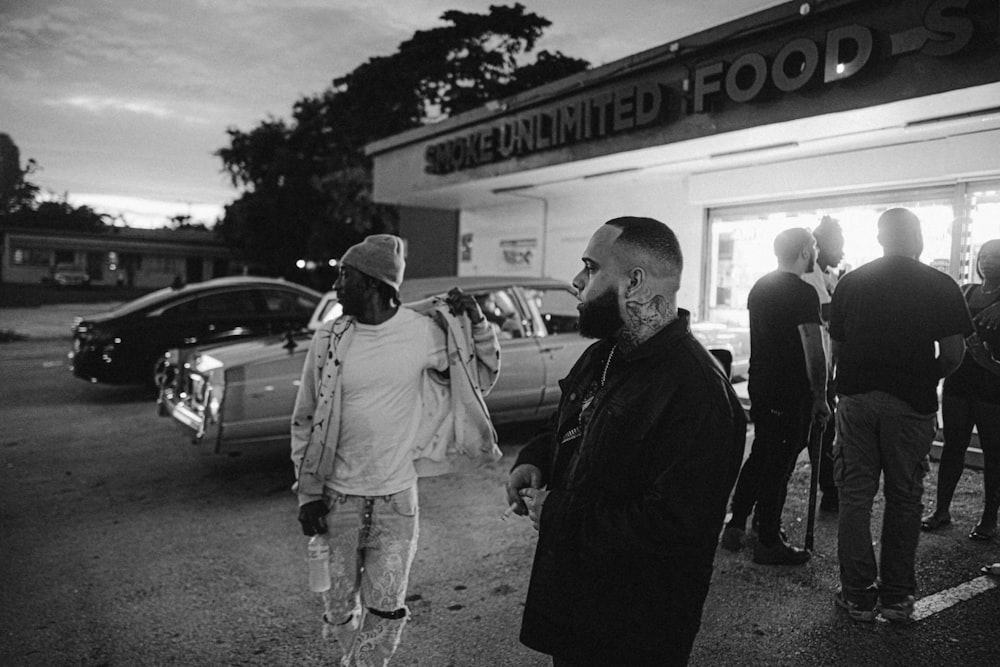 a group of people standing outside of a store