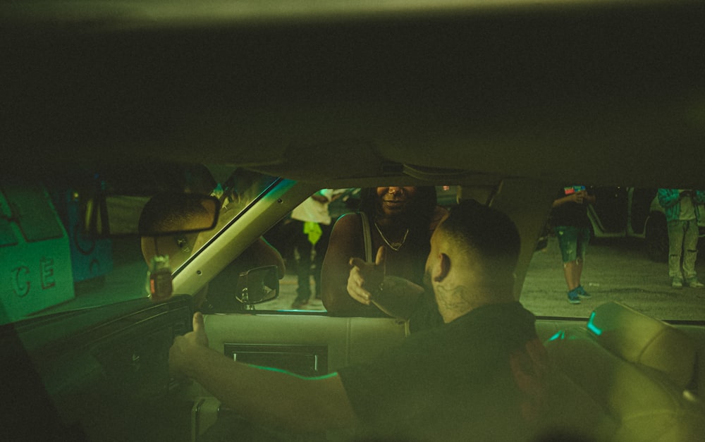 a group of people sitting in the back of a car