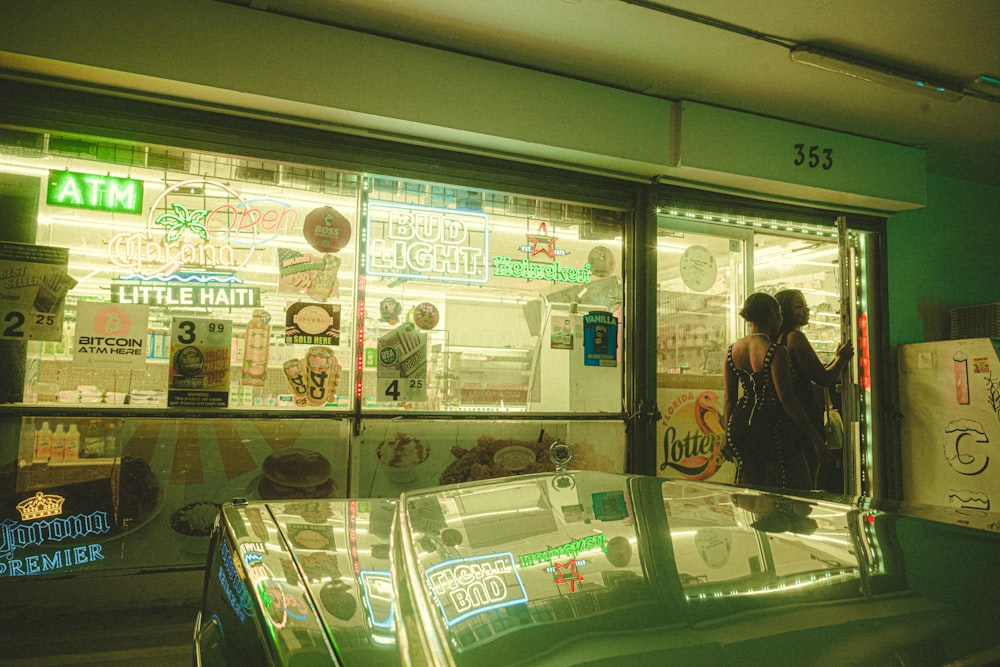 a woman standing in front of a store window