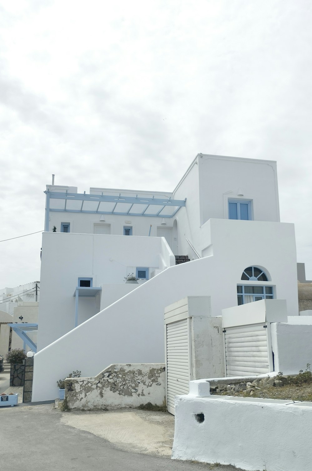 a white building with a staircase leading up to it