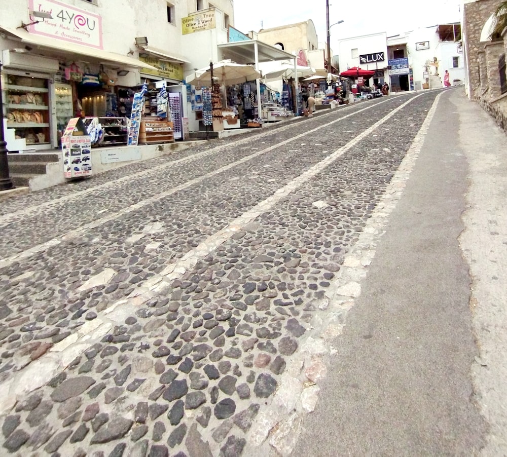 a cobblestone street lined with shops and shops