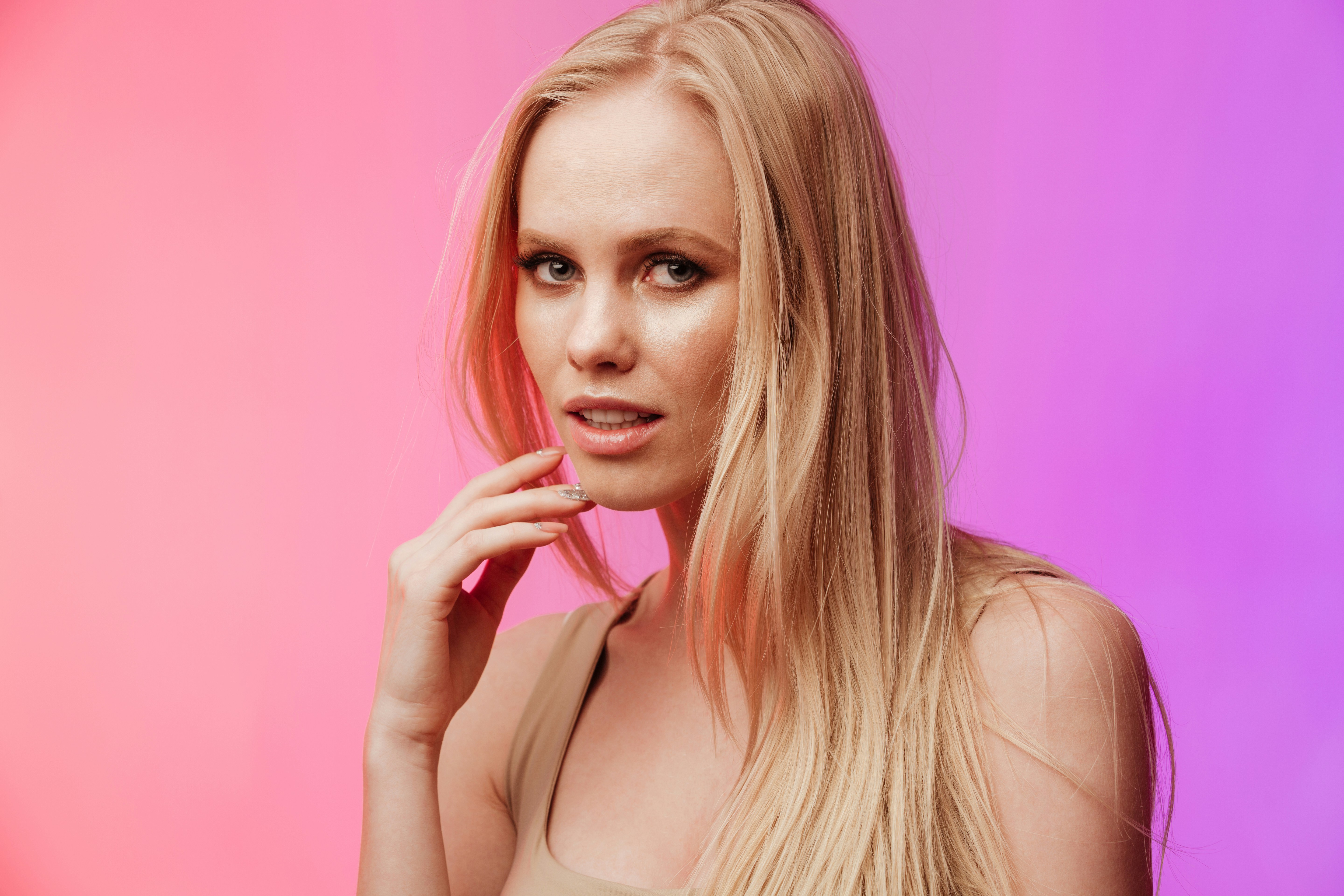 a woman with long blonde hair posing for a picture