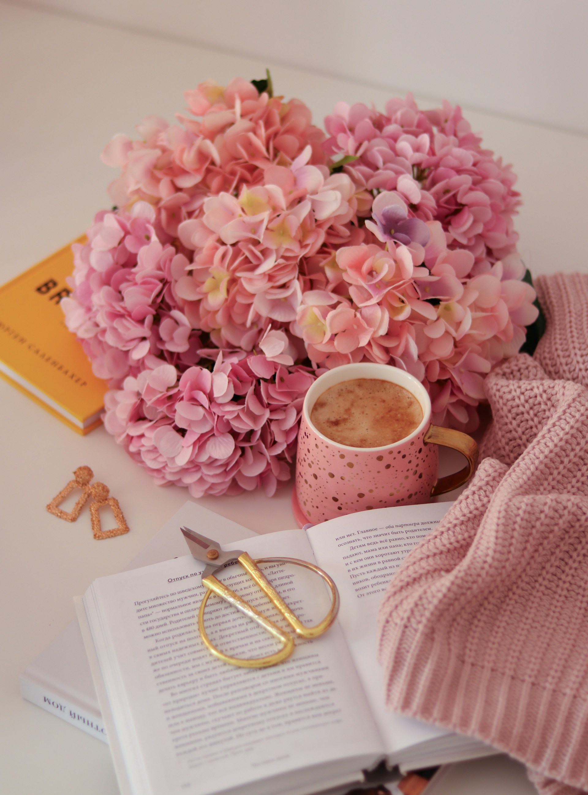 a cup of coffee and a pair of scissors on a table