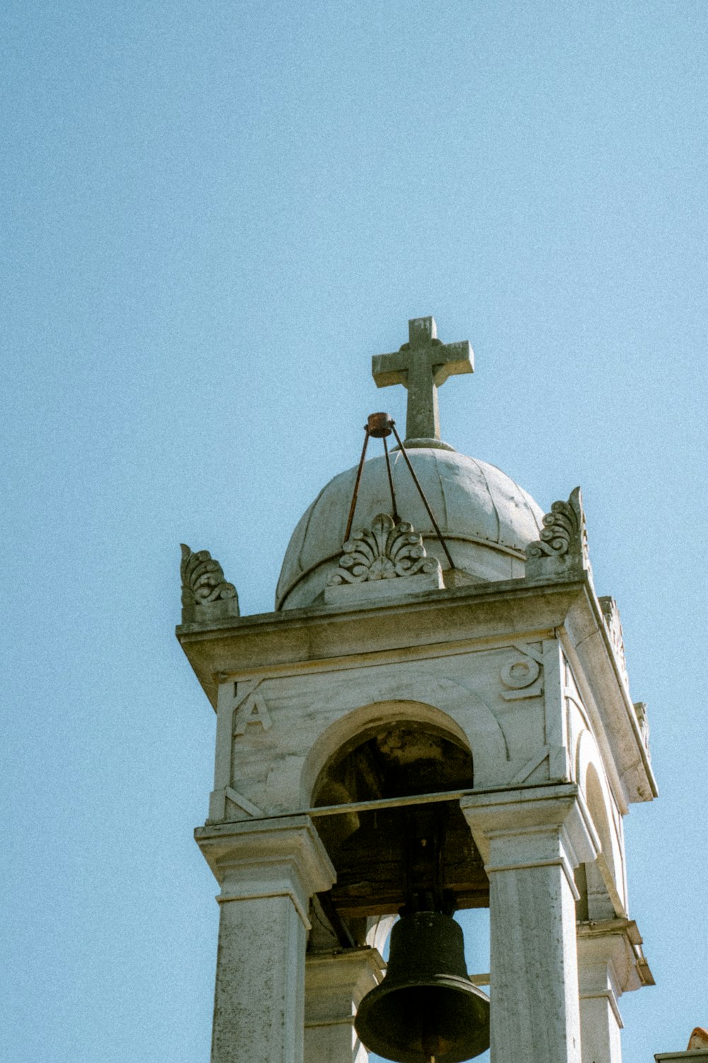 a bell tower with a cross on top