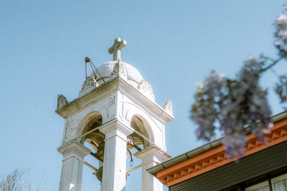 a bell tower with a cross on top of it