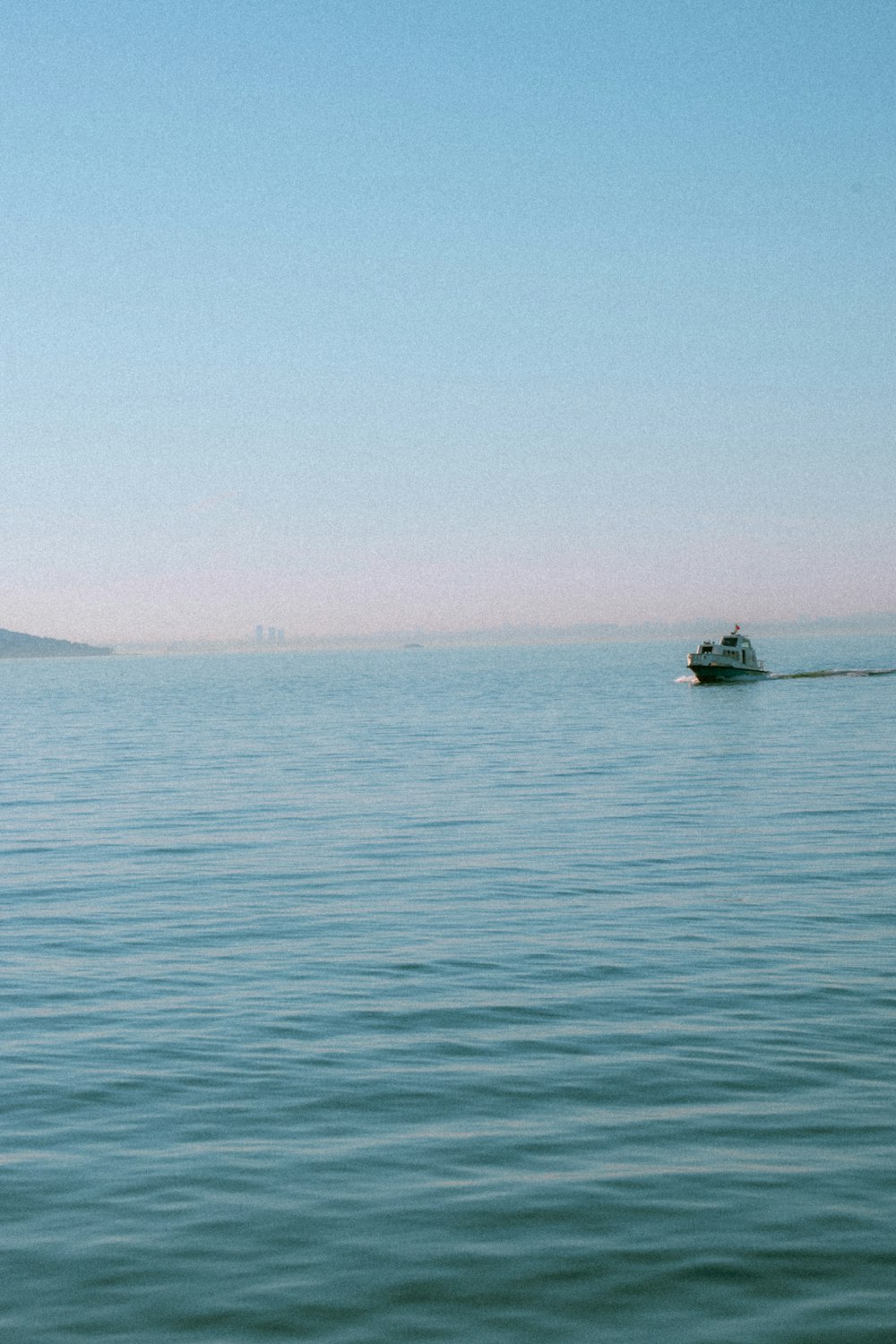 a boat floating on top of a large body of water