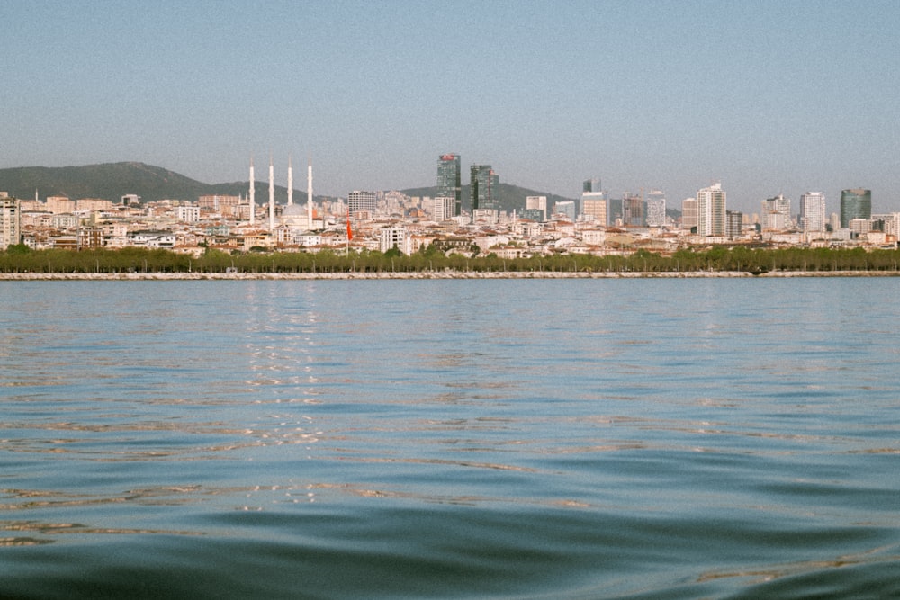 a large body of water with a city in the background