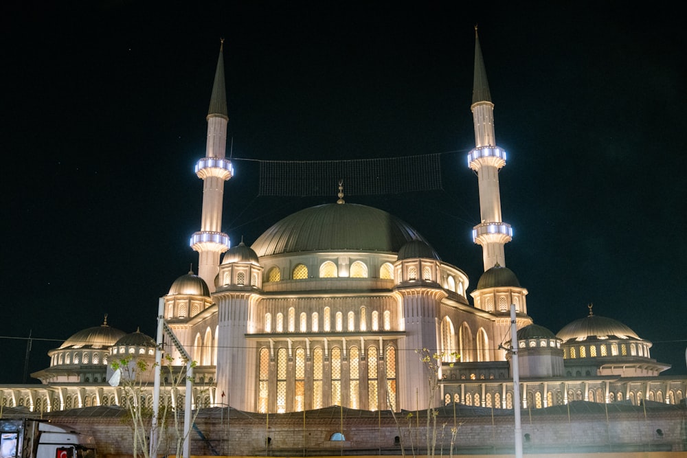 a large building lit up at night with lights on it