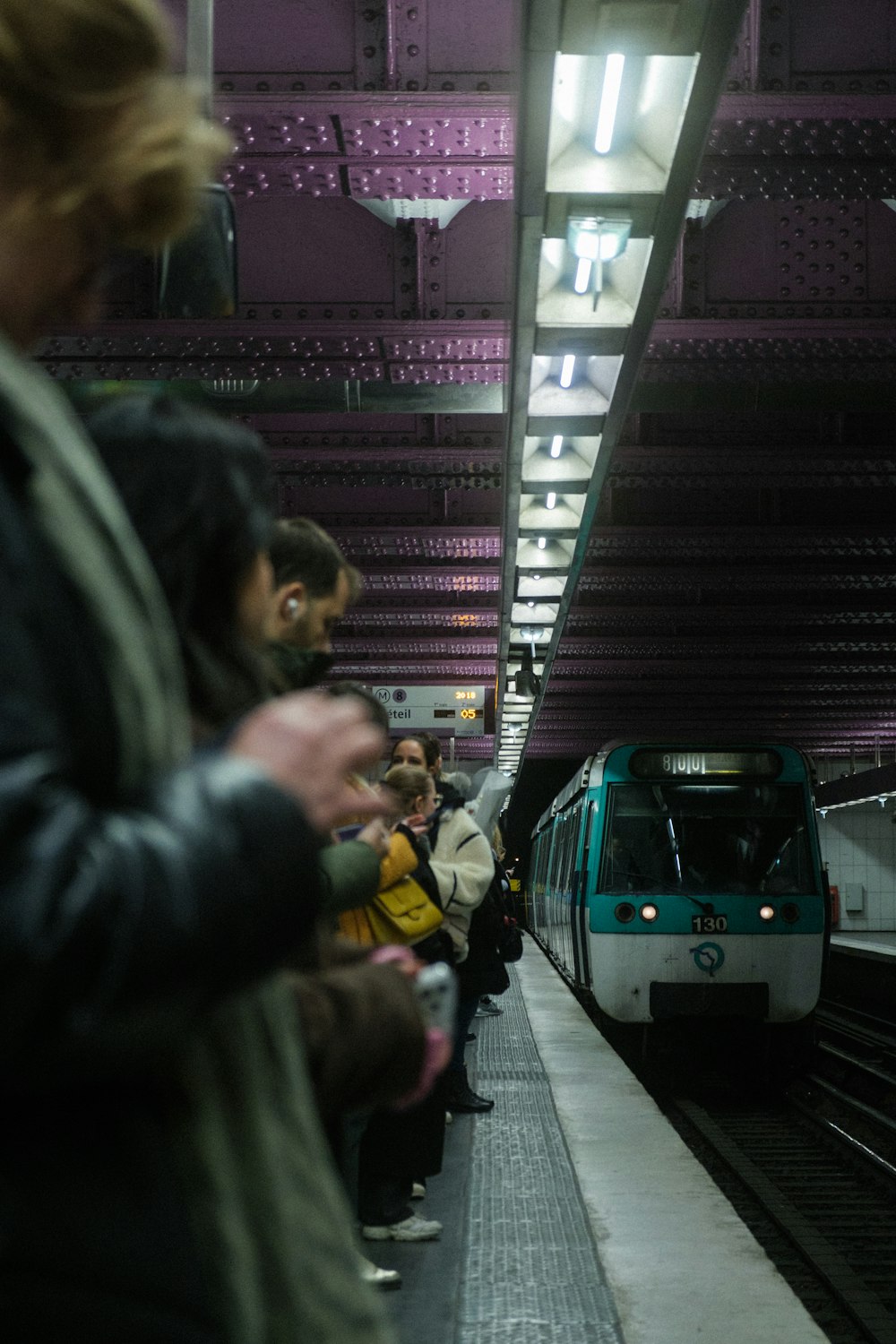 a group of people waiting to board a train