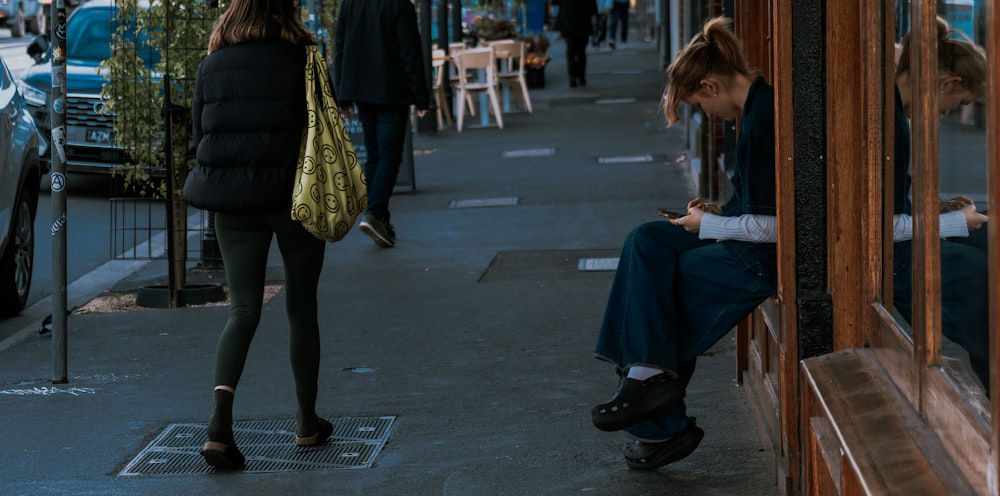 a woman sitting on a bench looking at her cell phone