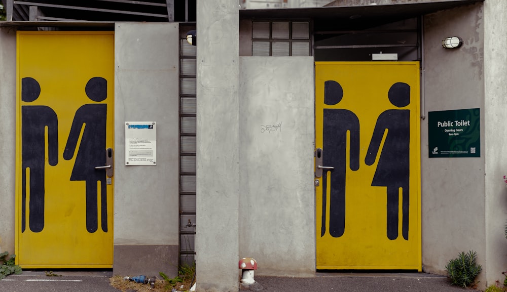 a couple of yellow doors with a man and a woman on them