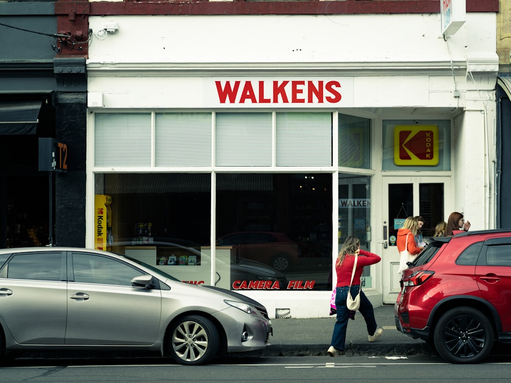 a couple of cars that are parked in front of a store