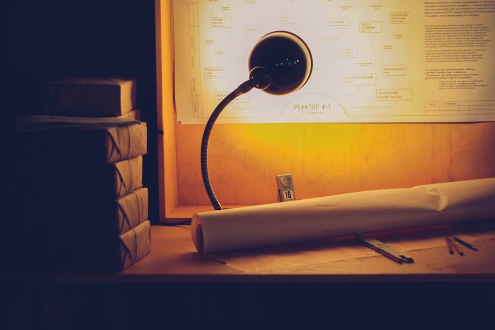 a desk lamp sitting on top of a wooden desk