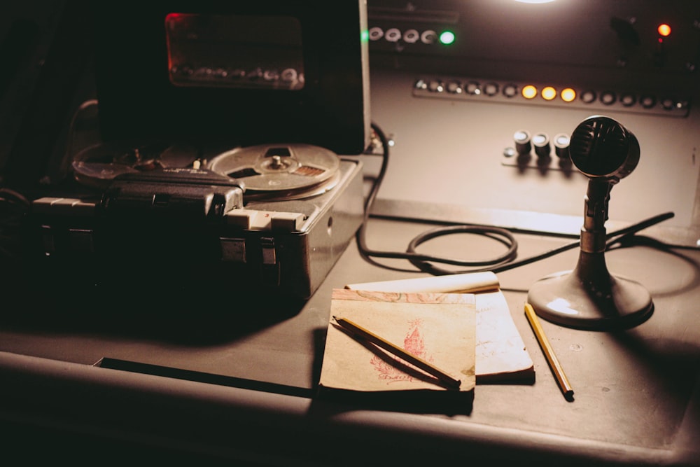 a table with a record player, a tape recorder, and a pair of scissors