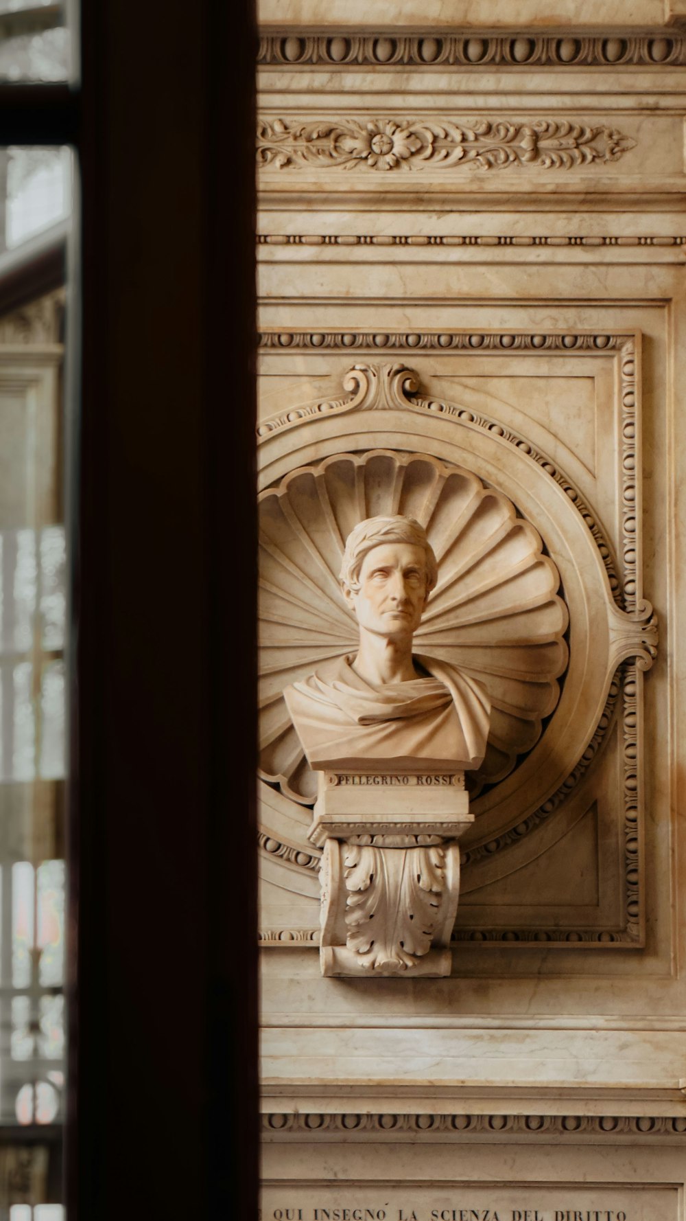 a close up of a statue on a wall