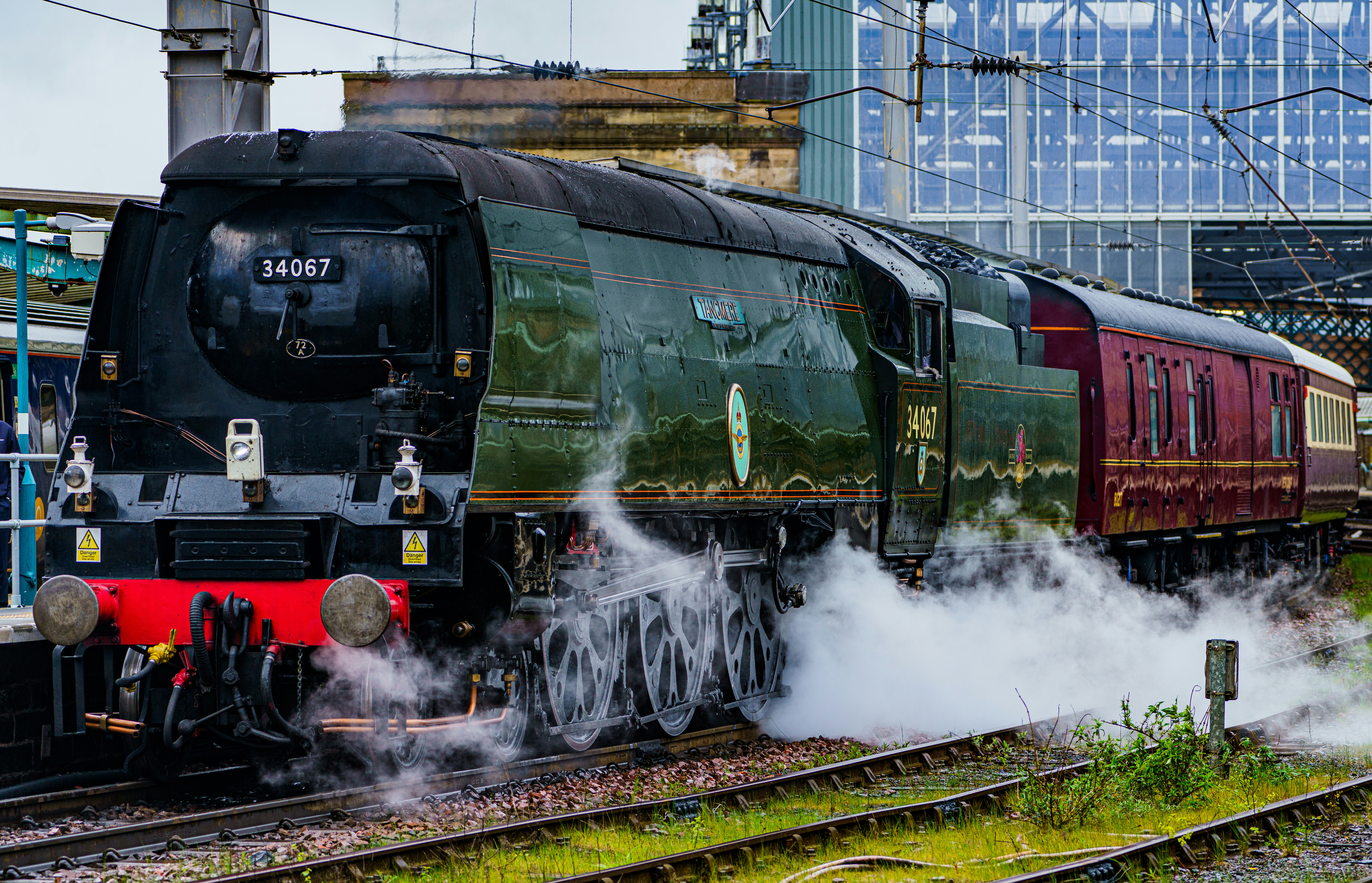a steam engine train traveling down train tracks