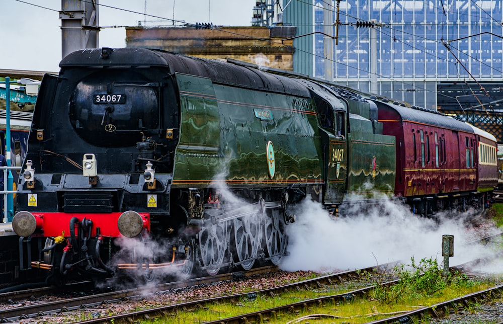 a steam engine train traveling down train tracks