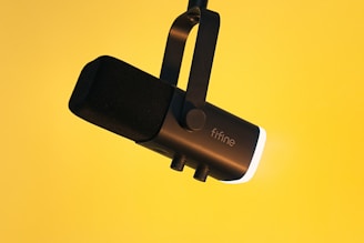a close up of a microphone on a yellow background